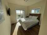 Quest bedroom with Queen size bed and direct access to lower deck and full beach view